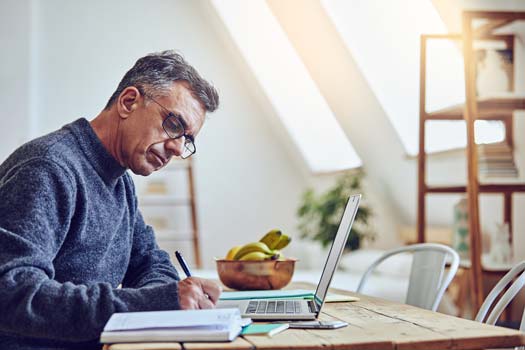 man at desk working on a computer